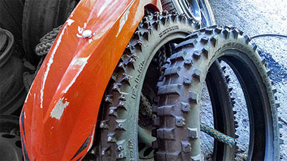 Crossipyörän irralliset etu- ja takarengas. Takarengas on selvästi kuluneempi.